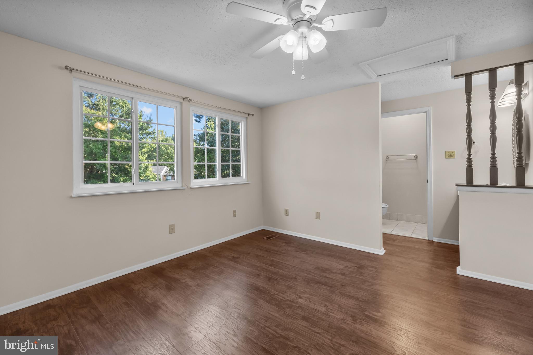 6832 Heatherway Court Alexandria, VA 22315 - Photo 22 of 37 an empty room with wooden floor fan and windows