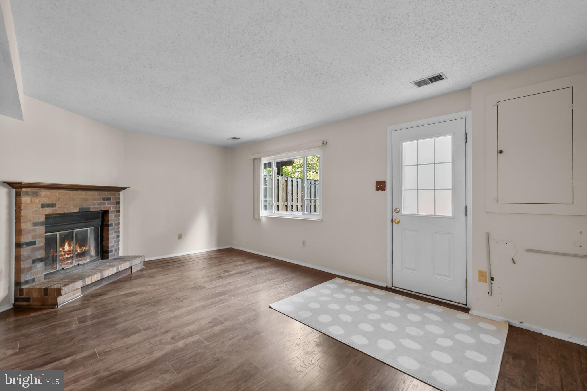 6832 Heatherway Court Alexandria, VA 22315 - Photo 29 of 37 an empty room with windows and fireplace