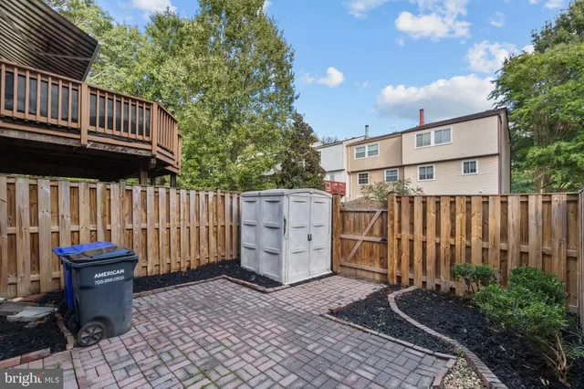 a view of a house with wooden fence