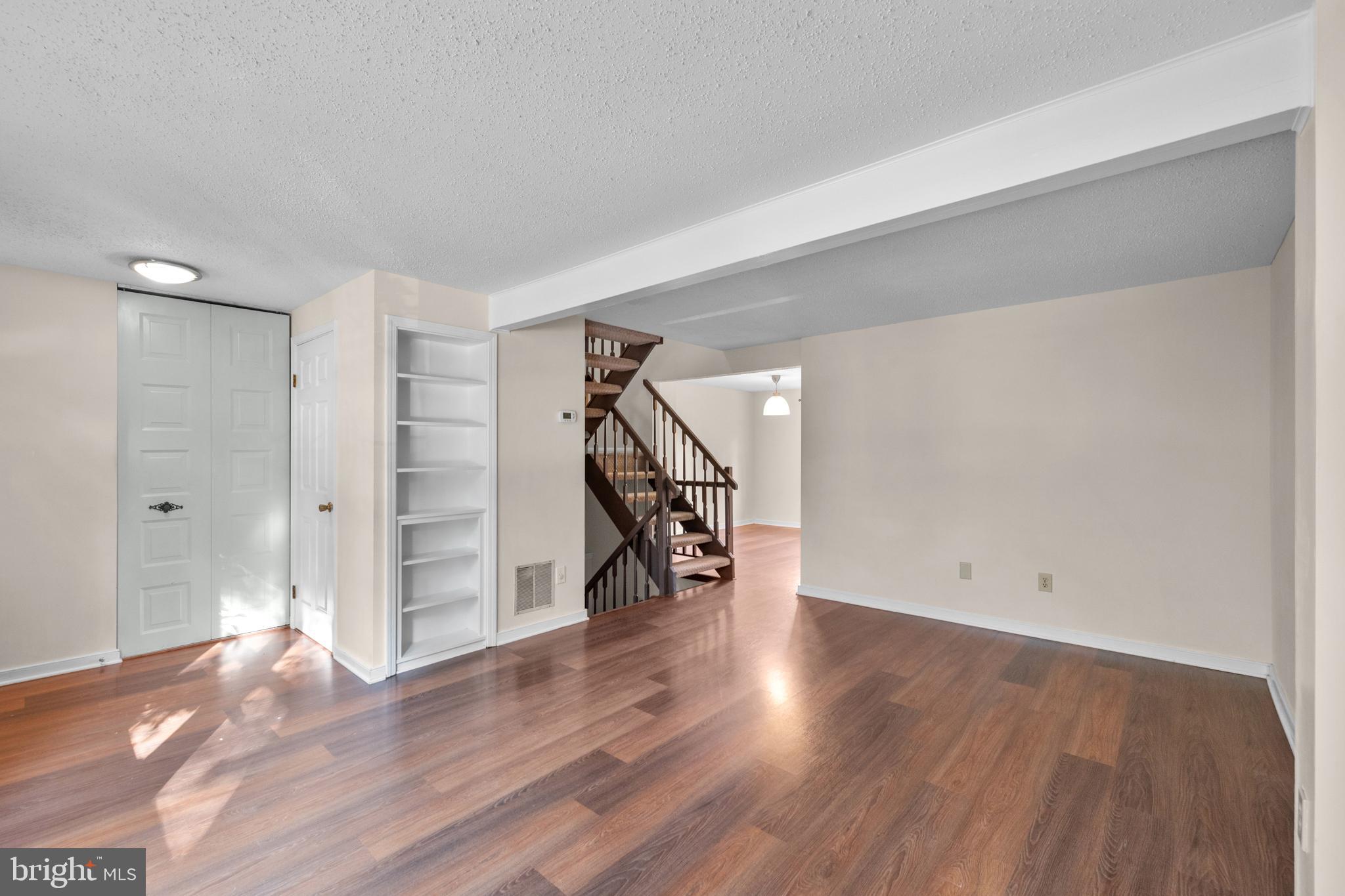 6832 Heatherway Court Alexandria, VA 22315 - Photo 4 of 37 a view of empty room with wooden floor and stairs
