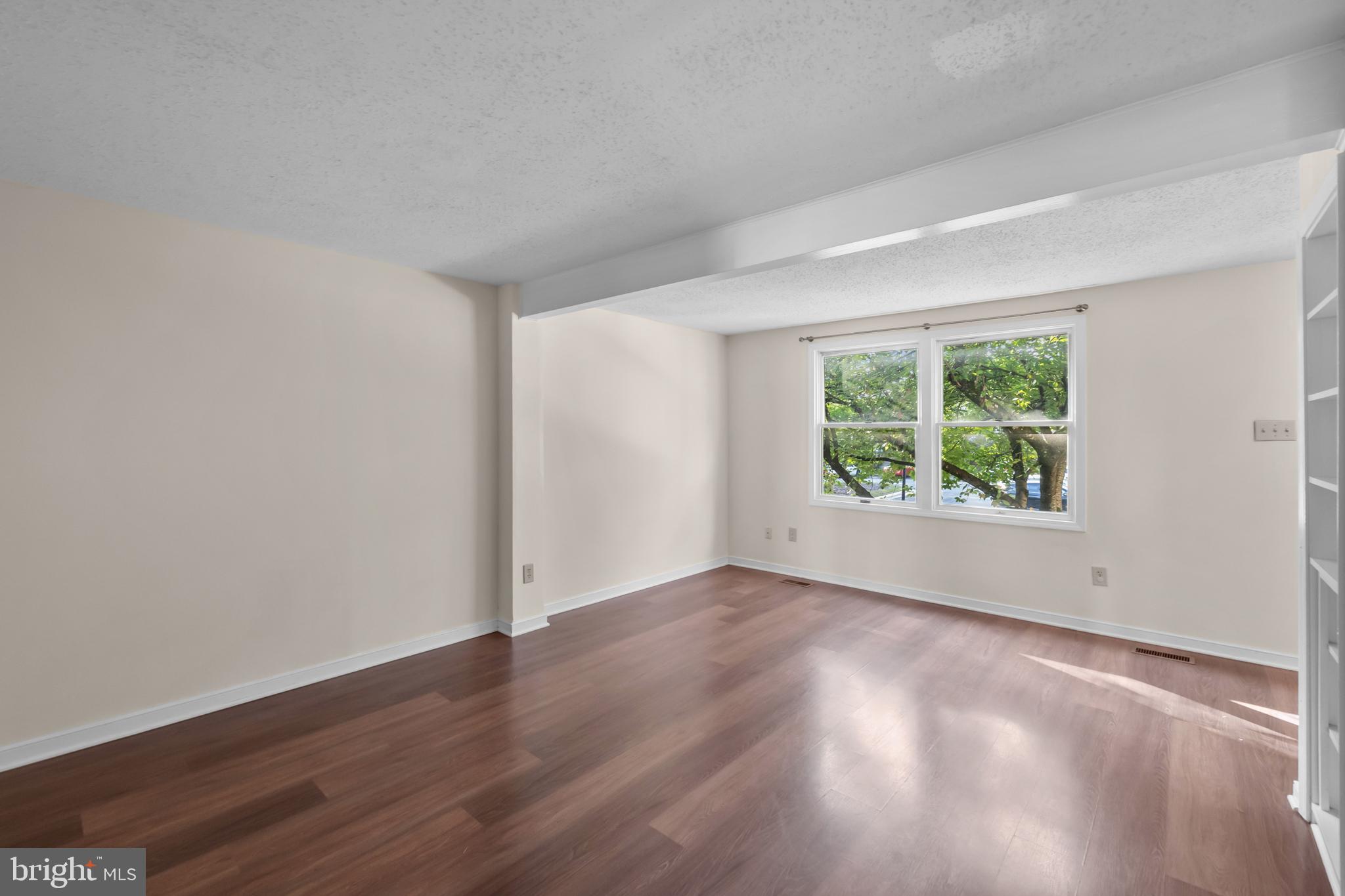 6832 Heatherway Court Alexandria, VA 22315 - Photo 6 of 37 an empty room with wooden floor and windows