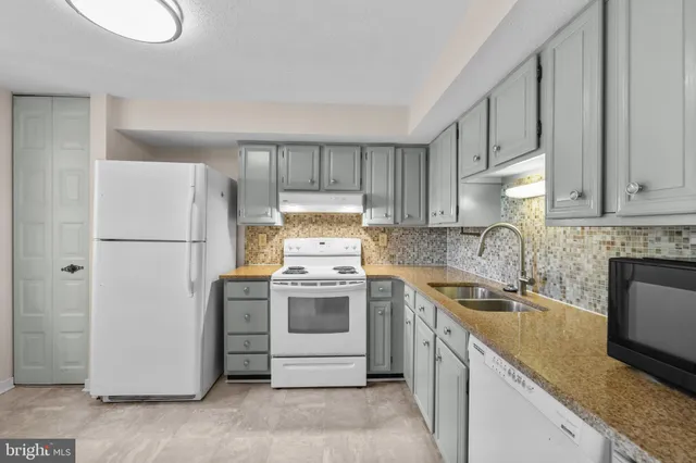 a kitchen with a sink stove and refrigerator