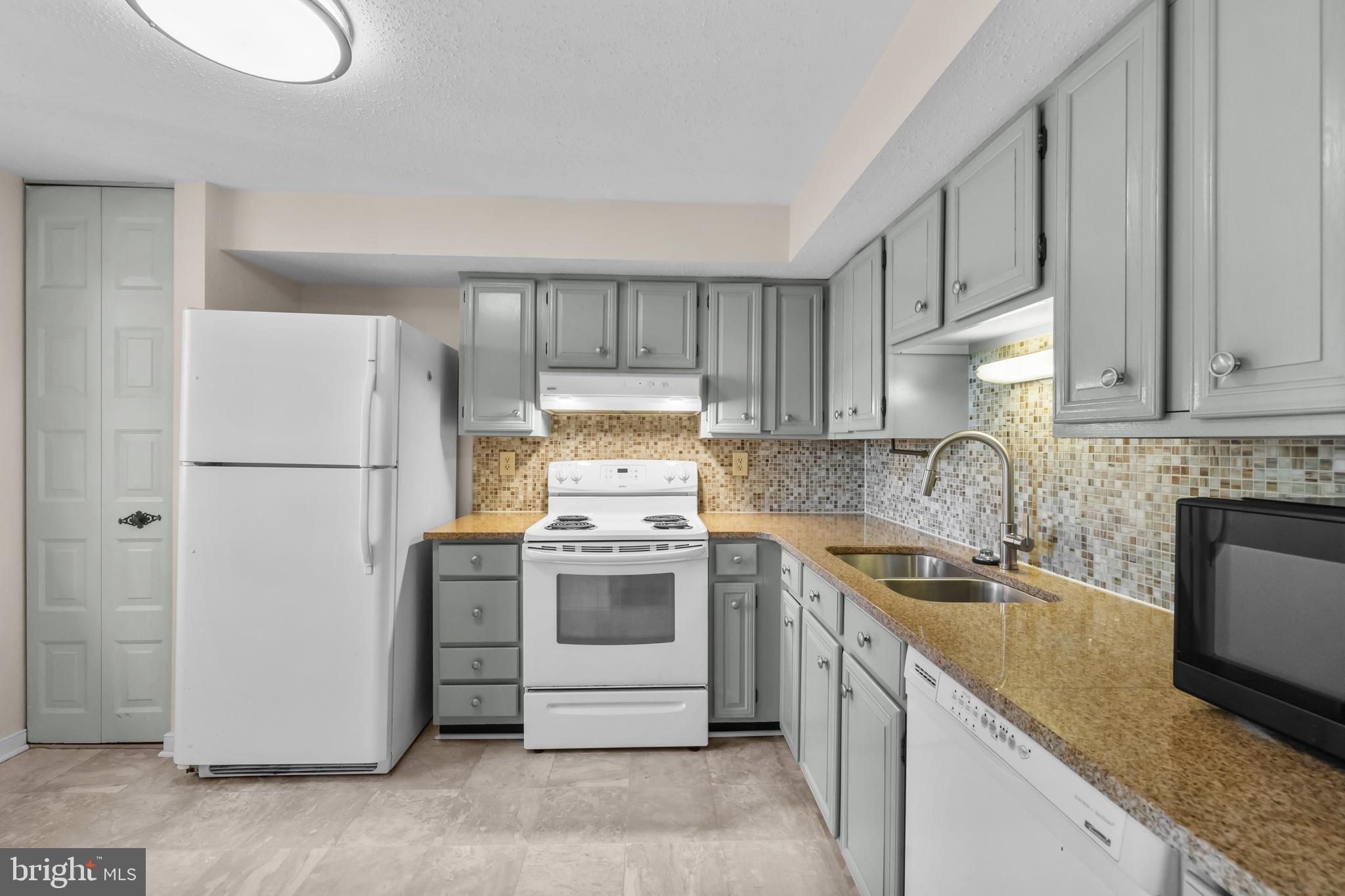 6832 Heatherway Court Alexandria, VA 22315 - Photo 9 of 37 a kitchen with a sink stove and refrigerator