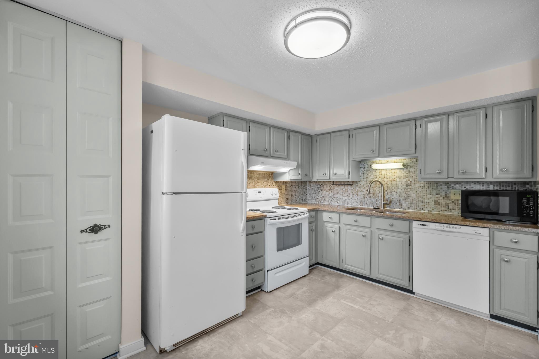 6832 Heatherway Court Alexandria, VA 22315 - Photo 10 of 37 a kitchen with appliances a sink and cabinets