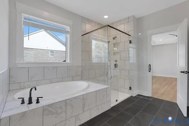 a spacious bathroom with a bathtub and a shower