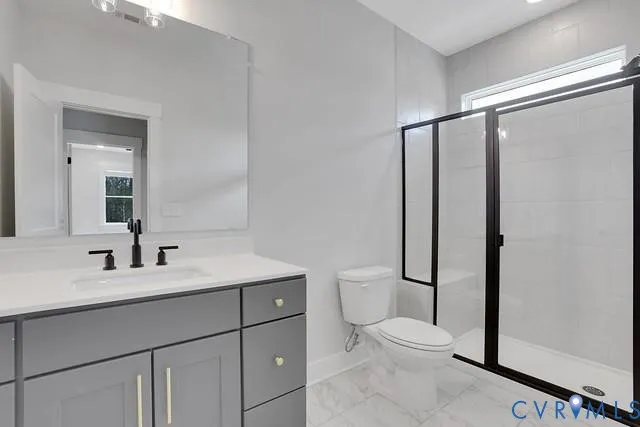 a bathroom with a toilet a sink and a mirror