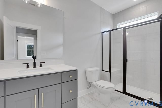 3951 Jett Court Gum Spring, VA 23065 - Photo 10 of 12 a bathroom with a toilet a sink and a mirror