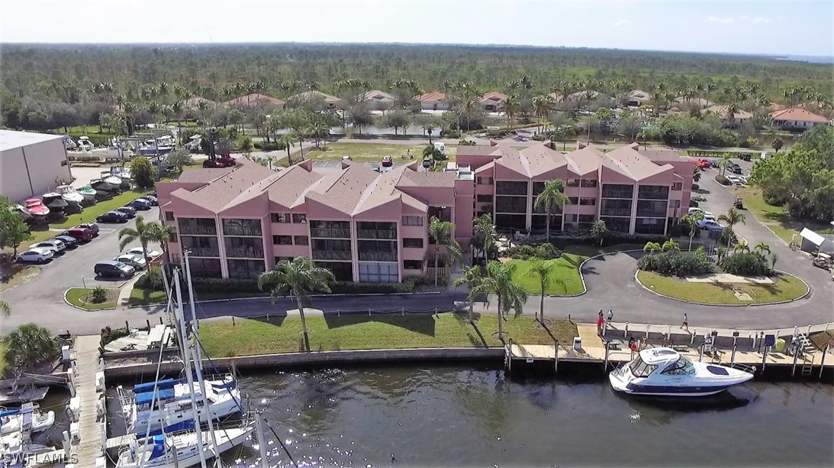 an aerial view of a house with swimming pool and a yard