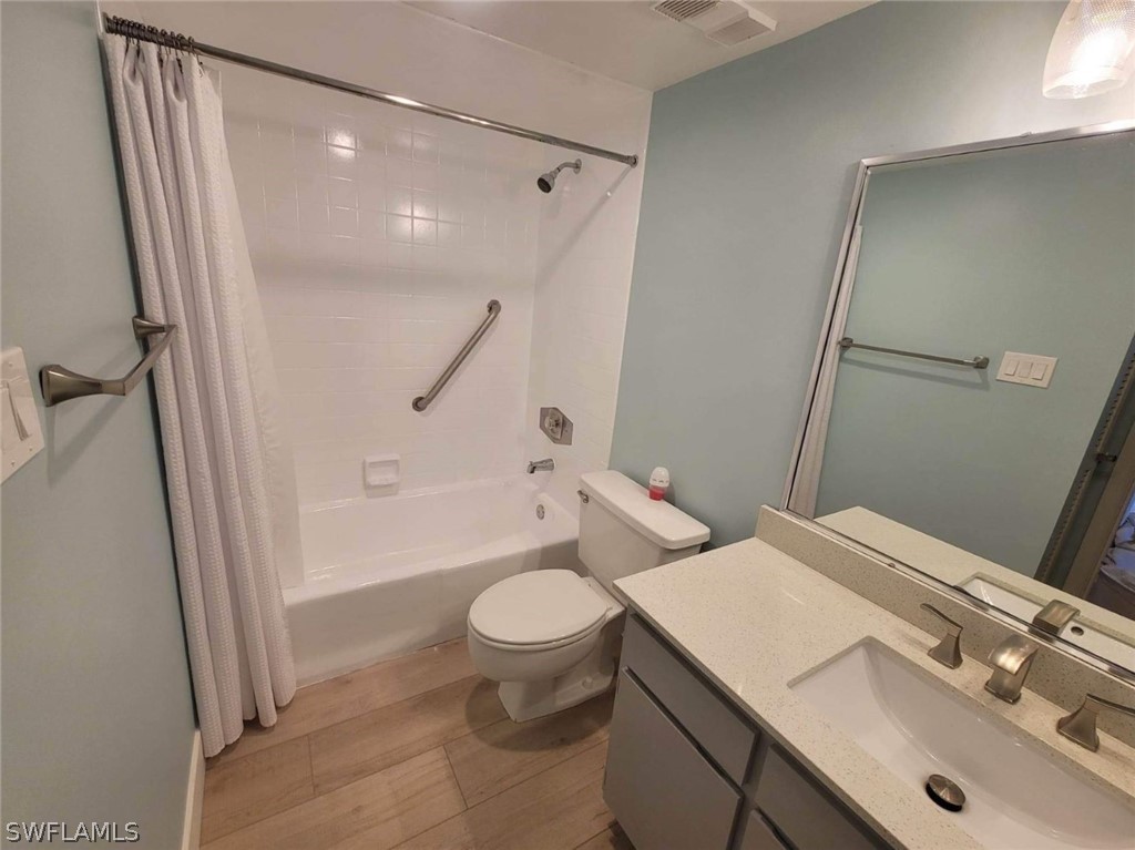 3170 Matecumbe Key Road, Unit 134 Punta Gorda, FL 33955 - Photo 11 of 41 a bathroom with a sink a toilet a mirror and shower
