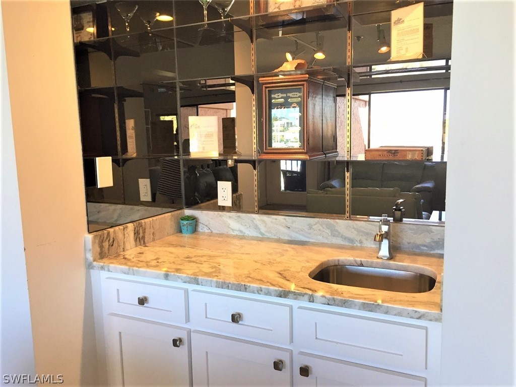 3170 Matecumbe Key Road, Unit 134 Punta Gorda, FL 33955 - Photo 20 of 41 a bathroom with a sink and a mirror