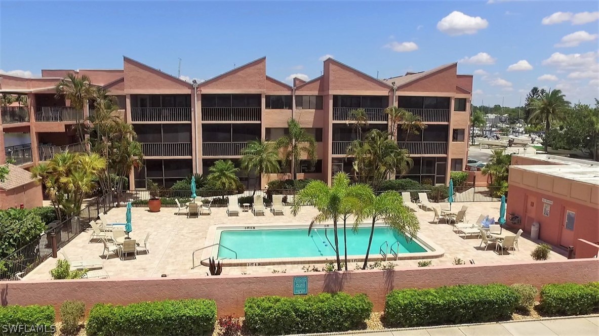 3170 Matecumbe Key Road, Unit 134 Punta Gorda, FL 33955 - Photo 2 of 41 a view of a building with garden and patio