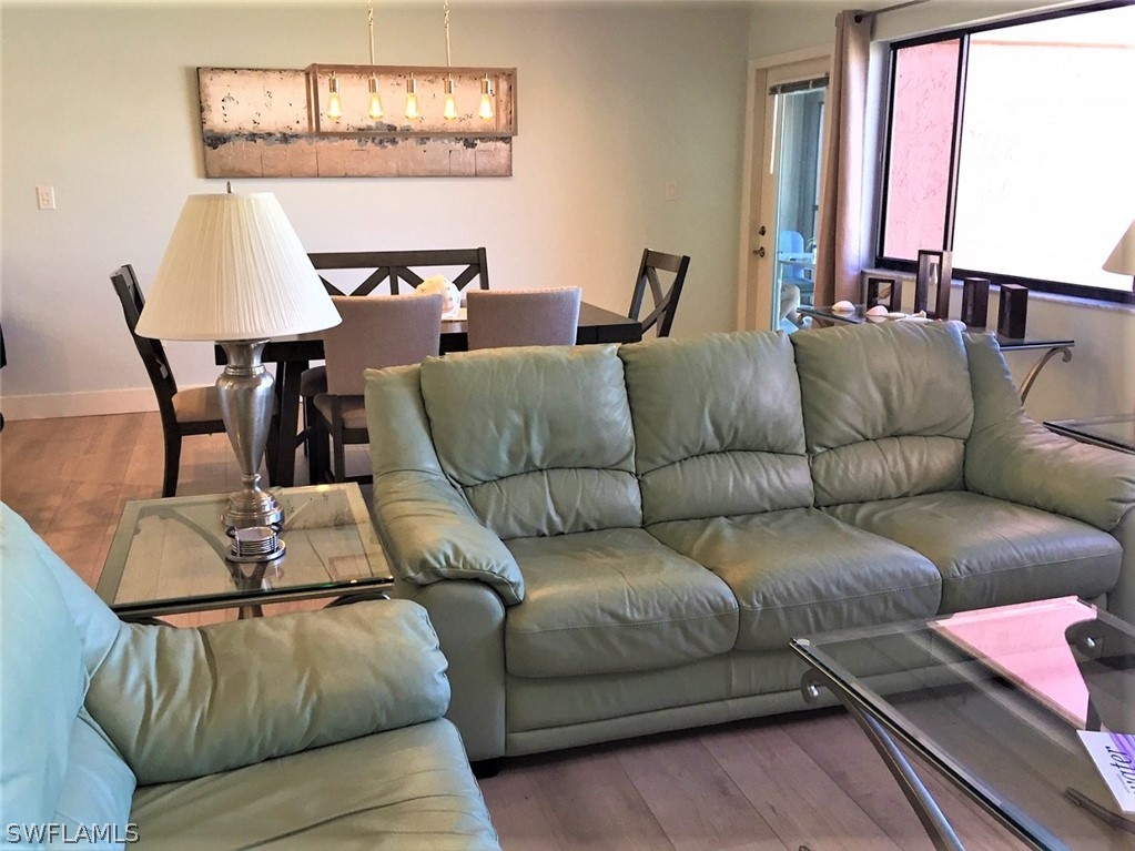 3170 Matecumbe Key Road, Unit 134 Punta Gorda, FL 33955 - Photo 22 of 41 a living room with furniture and wooden floor