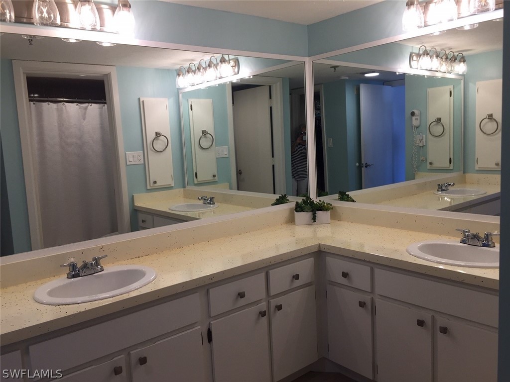 3170 Matecumbe Key Road, Unit 134 Punta Gorda, FL 33955 - Photo 25 of 41 a bathroom with double vanity sinks and a mirror