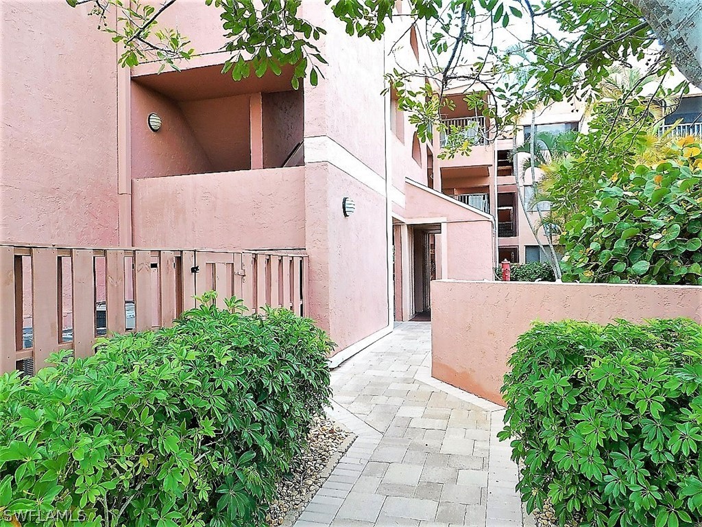 3170 Matecumbe Key Road, Unit 134 Punta Gorda, FL 33955 - Photo 32 of 41 a view of a house with a yard and potted plants