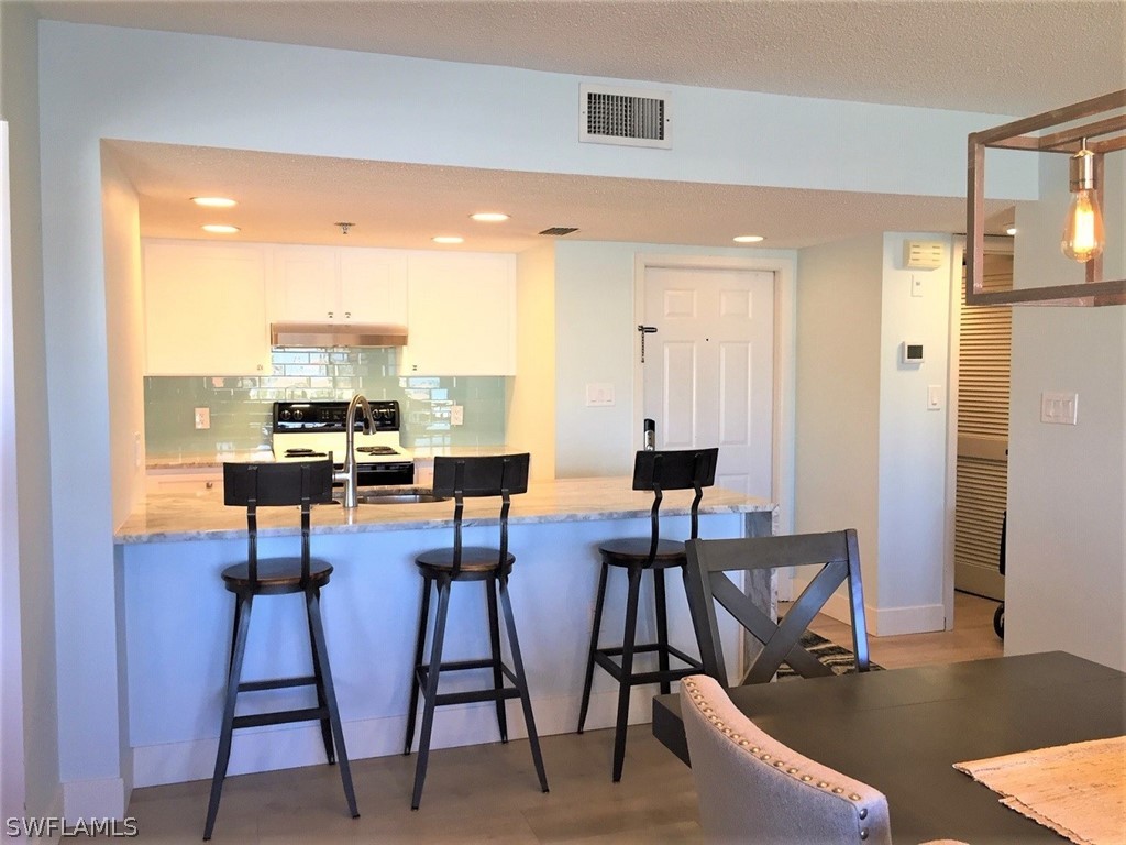 3170 Matecumbe Key Road, Unit 134 Punta Gorda, FL 33955 - Photo 5 of 41 a view of a dining room with furniture and wooden floor