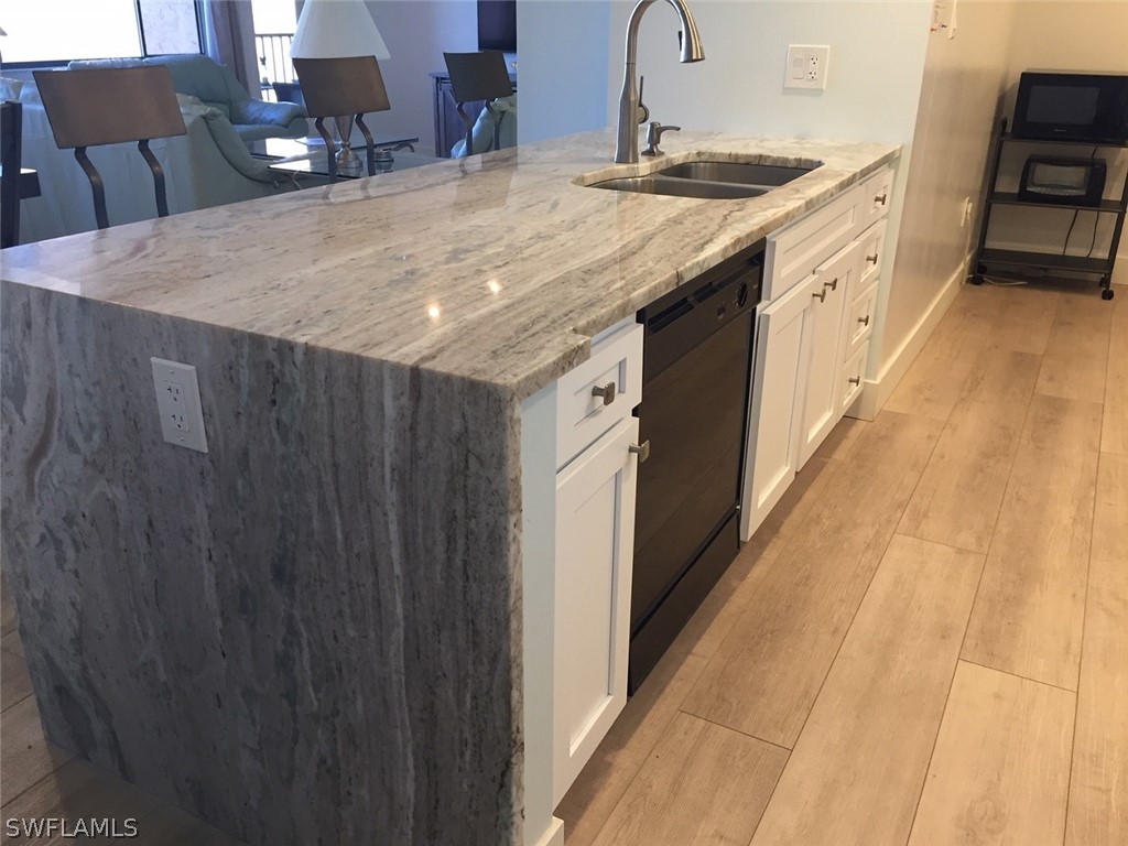 3170 Matecumbe Key Road, Unit 134 Punta Gorda, FL 33955 - Photo 6 of 41 a bathroom with a granite countertop sink and a mirror