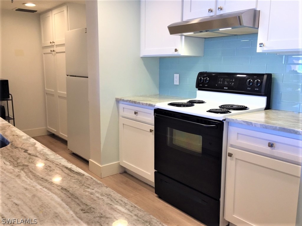 3170 Matecumbe Key Road, Unit 134 Punta Gorda, FL 33955 - Photo 10 of 41 a stove top oven sitting inside of a kitchen