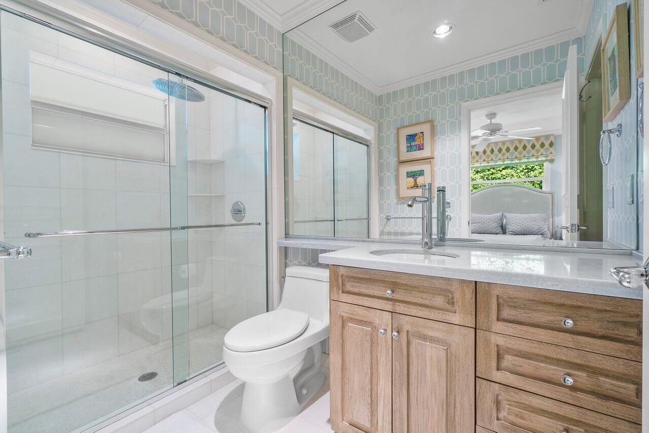 2377 East Silver Palm Road Boca Raton, FL 33432 - Photo 25 of 40 a bathroom with a granite countertop sink a toilet and shower
