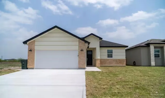a front view of house with garage and yard