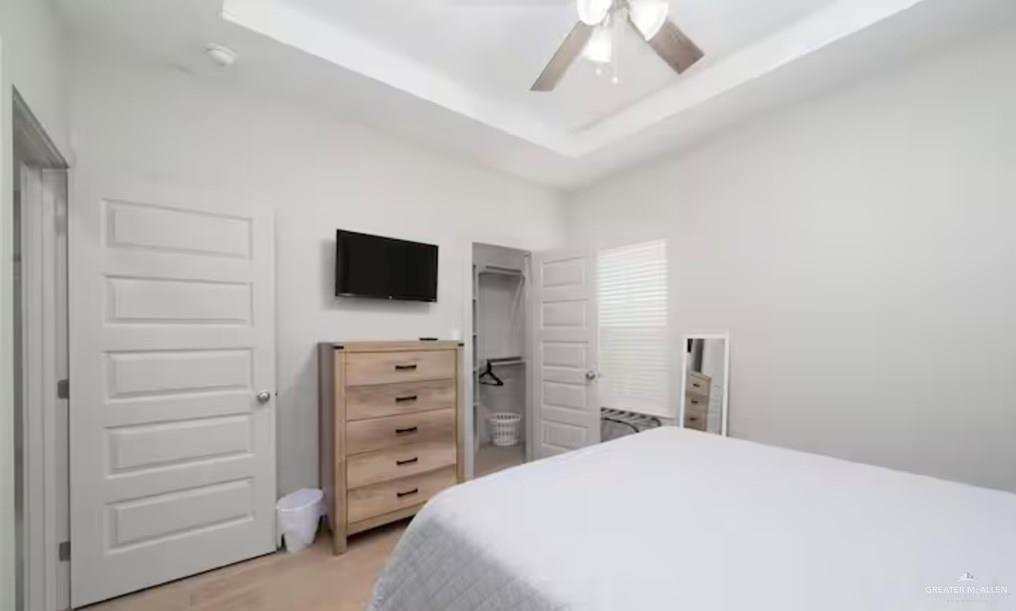 2402 Treasure Cove Harlingen, TX 78550 - Photo 11 of 22 a bedroom with a bed and a flat tv screen