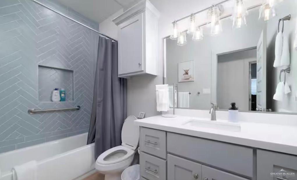 2402 Treasure Cove Harlingen, TX 78550 - Photo 13 of 22 a bathroom with a double vanity sink toilet mirror and bathtub