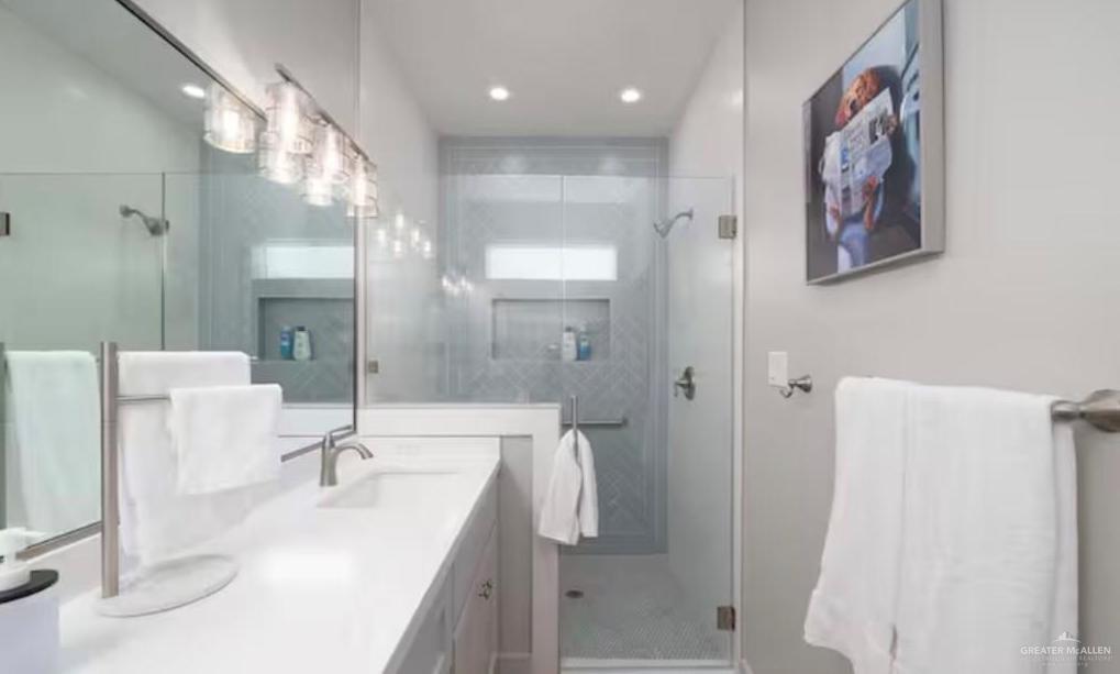 2402 Treasure Cove Harlingen, TX 78550 - Photo 14 of 22 a bathroom with a double vanity sink mirror and shower