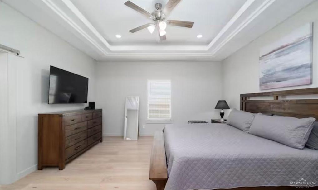 2402 Treasure Cove Harlingen, TX 78550 - Photo 16 of 22 a bedroom with a bed and a flat screen tv