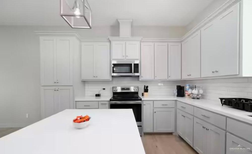 2402 Treasure Cove Harlingen, TX 78550 - Photo 19 of 22 a kitchen with white cabinets and appliances
