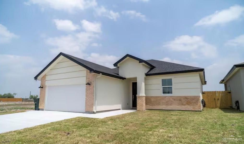 2402 Treasure Cove Harlingen, TX 78550 - Photo 2 of 22 a view of a house with a yard and garage