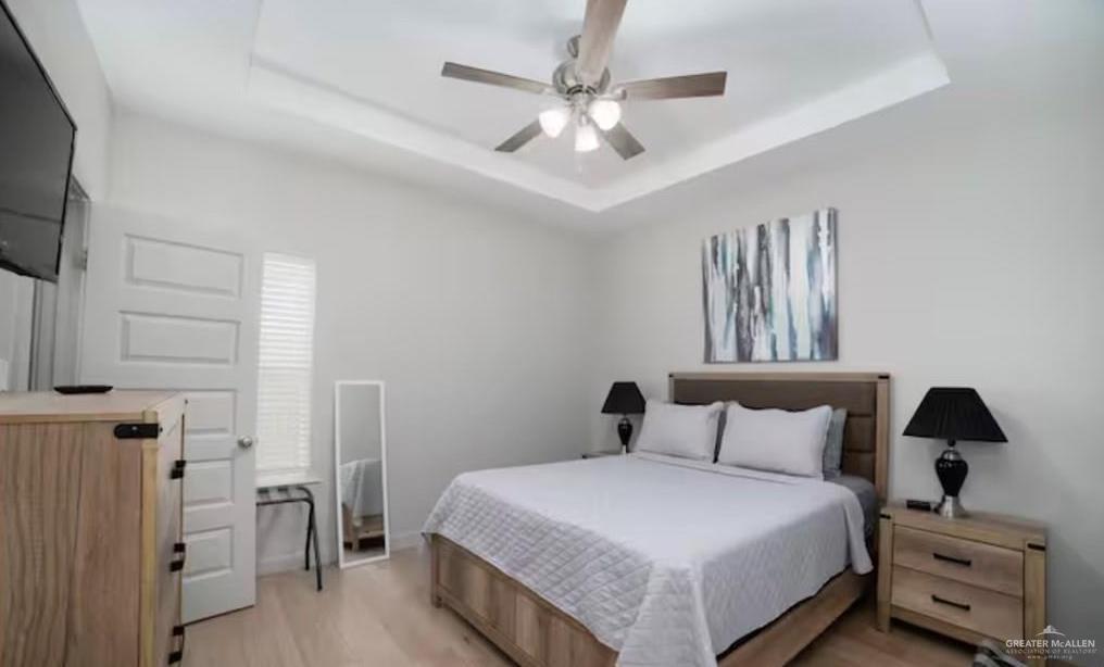 2402 Treasure Cove Harlingen, TX 78550 - Photo 9 of 22 a bedroom with a bed and a chandelier