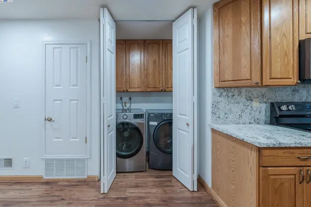 a view of a storage and utility room with washer and dryer