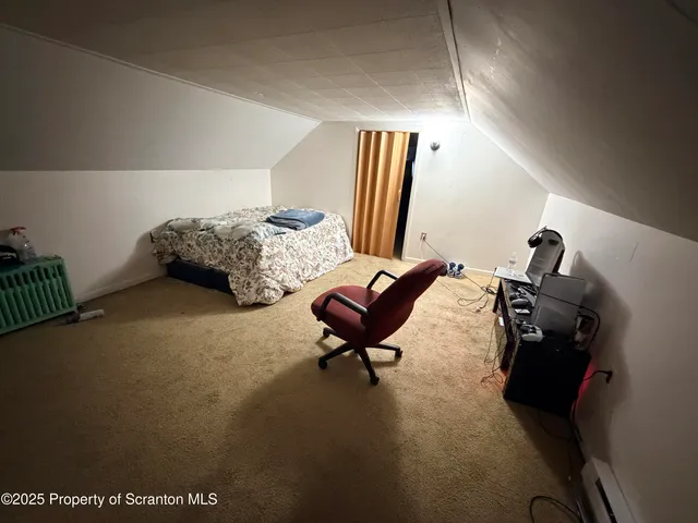 a bedroom with furniture and a air conditioner vent