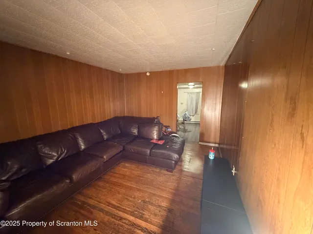 a living room with a couch and a view of kitchen