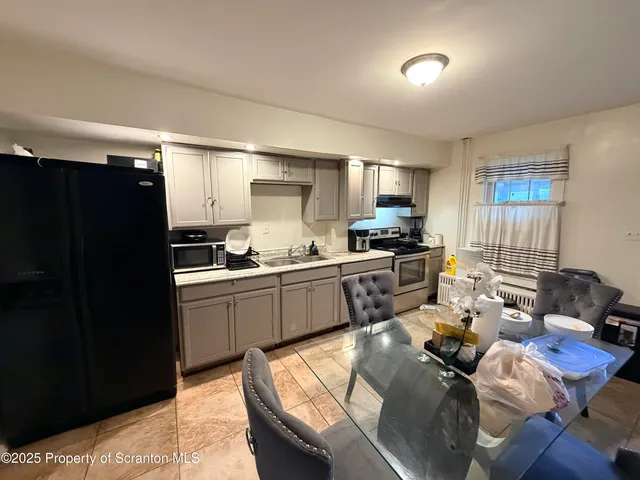 a kitchen with sink refrigerator and cabinets