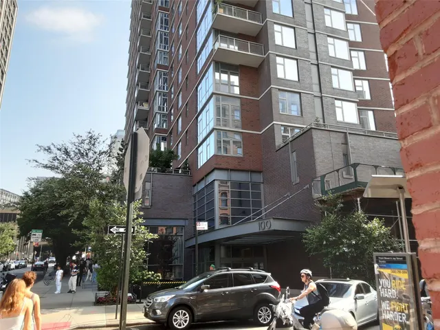 a front view of a building and car parked