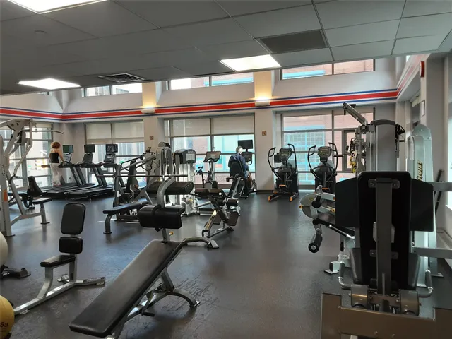 a room with gym equipment and a large window