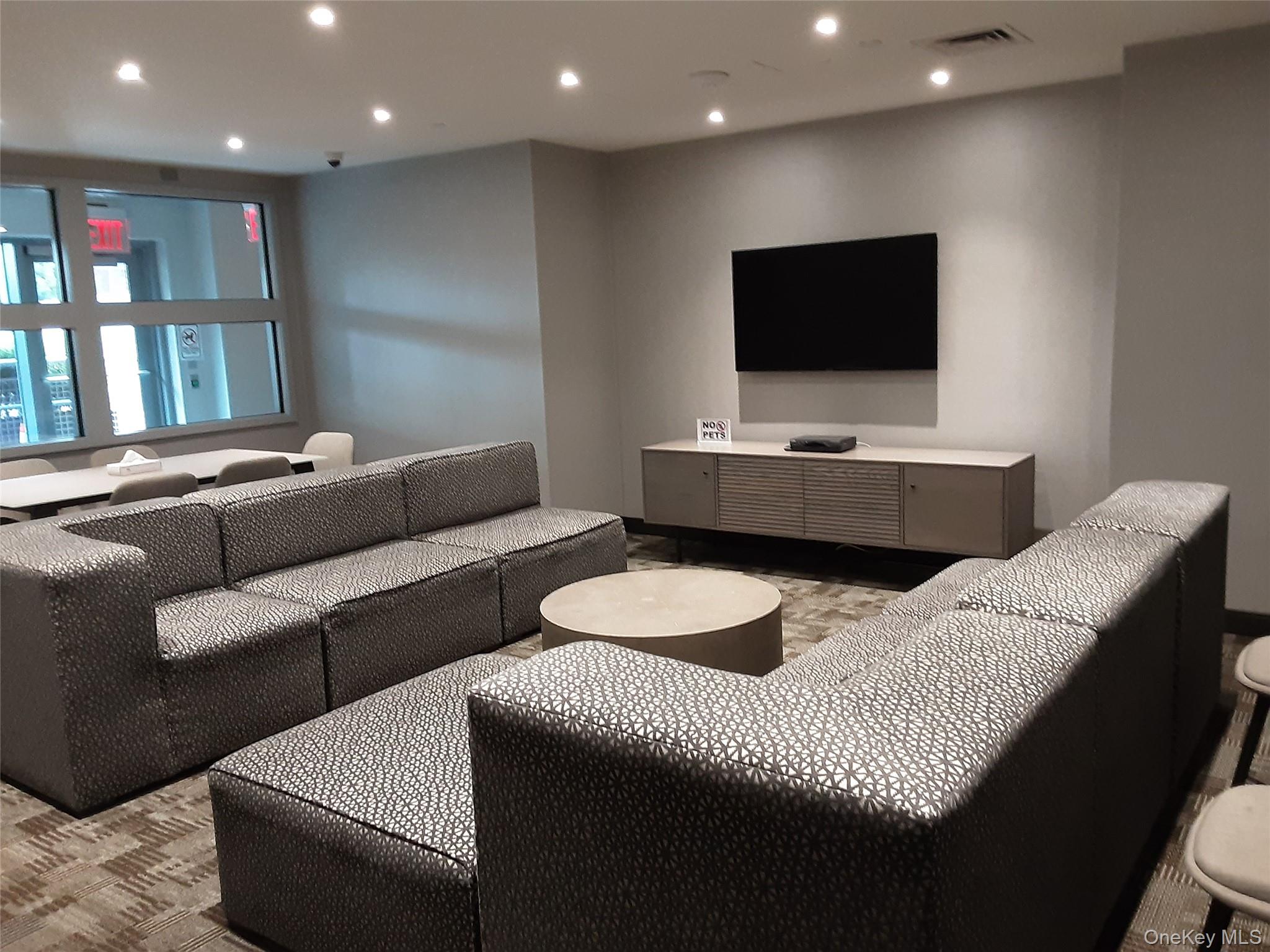 100 Jay Street, Unit 28B Brooklyn, NY 11201 - Photo 17 of 47 a living room with furniture and a flat screen tv