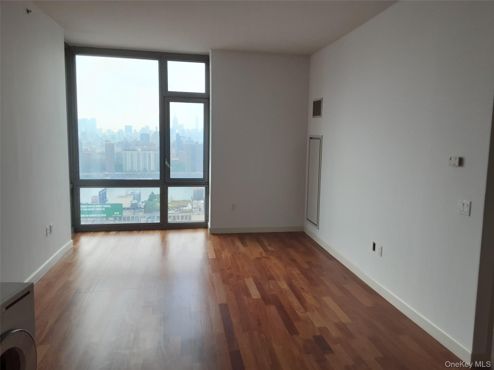 100 Jay Street, Unit 28B Brooklyn, NY 11201 - Photo 18 of 47 wooden floor in an empty room with a window