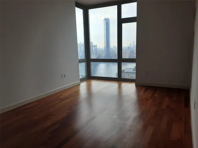a view of wooden floor and windows in a room
