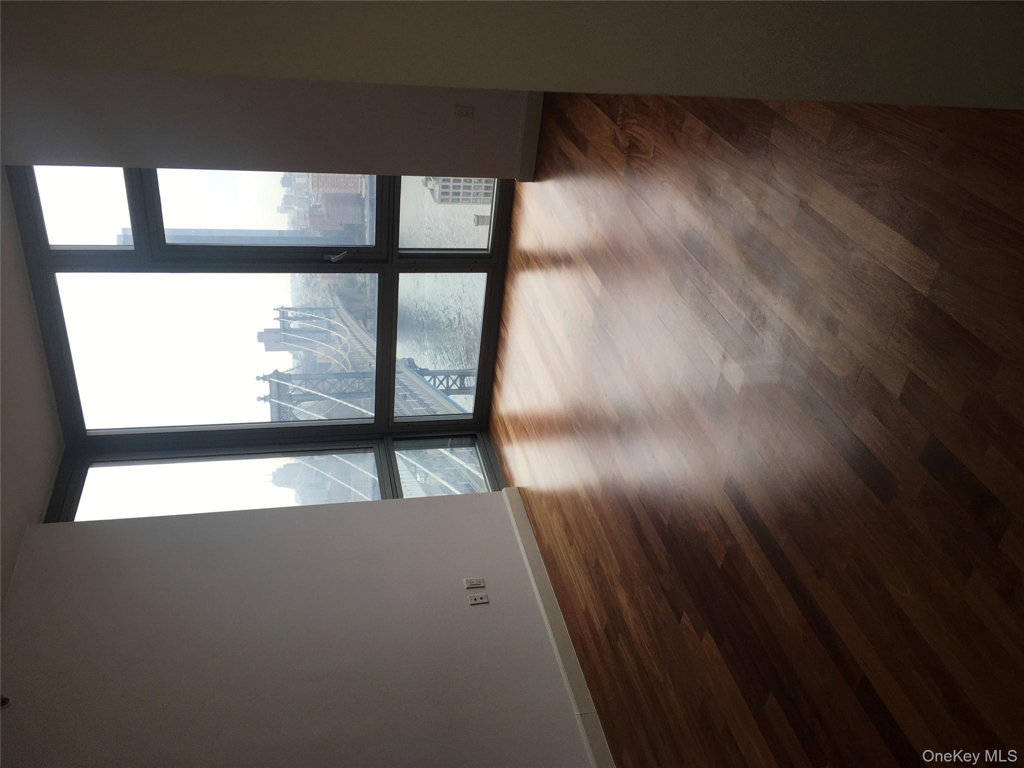 100 Jay Street, Unit 28B Brooklyn, NY 11201 - Photo 20 of 47 a view of a room with wooden floor and a window