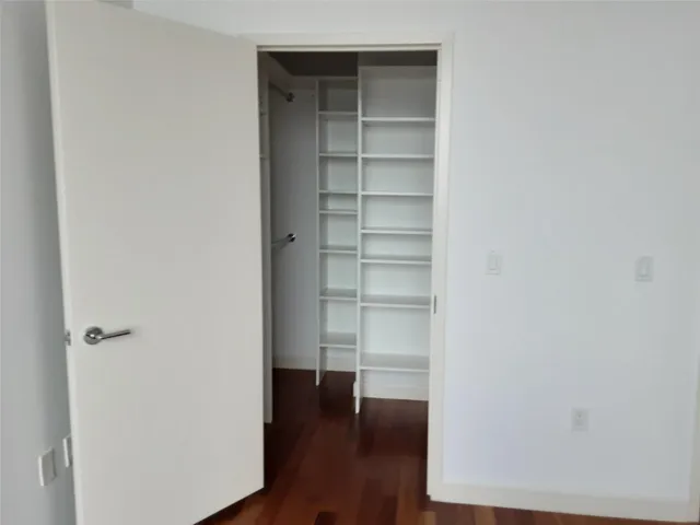 a view of a room with wooden floor