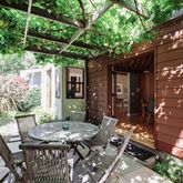 a view of a patio with table and chairs and potted plants