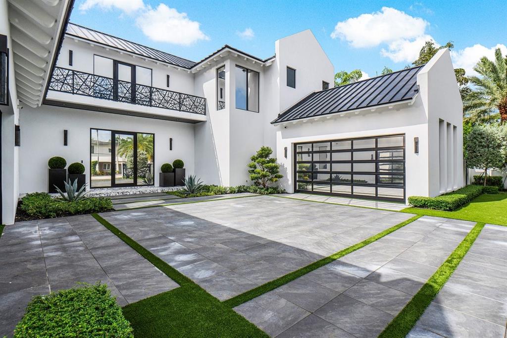 202 Northwest 7th Street Delray Beach, FL 33444 - Photo 3 of 100 a front view of a house with a yard and garage