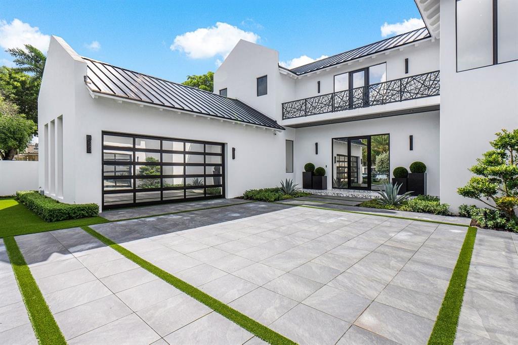 202 Northwest 7th Street Delray Beach, FL 33444 - Photo 4 of 100 a front view of a house with a yard and garage