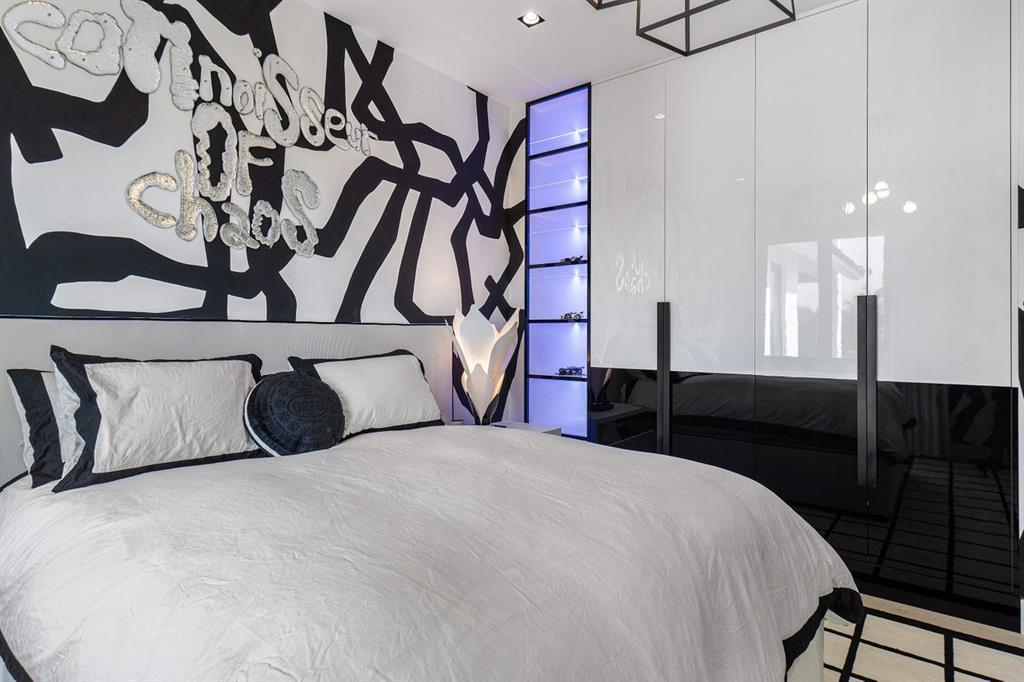 202 Northwest 7th Street Delray Beach, FL 33444 - Photo 49 of 100 a bedroom with a bed and a chandelier