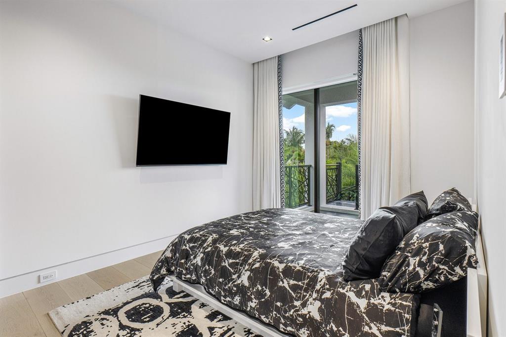 202 Northwest 7th Street Delray Beach, FL 33444 - Photo 55 of 100 a bedroom with a bed and flat screen tv