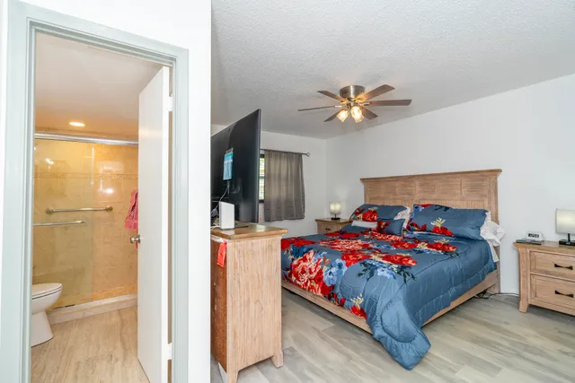 a bedroom with a large bed and a flat screen tv