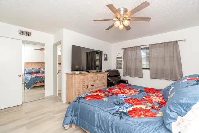 a bedroom with a bed and a chandelier