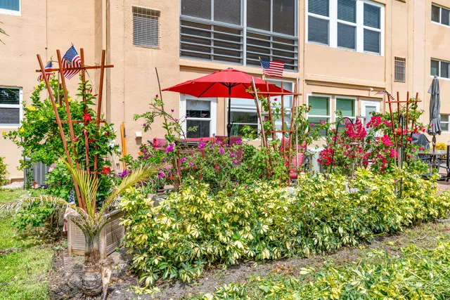 a view of a house with a yard and garden