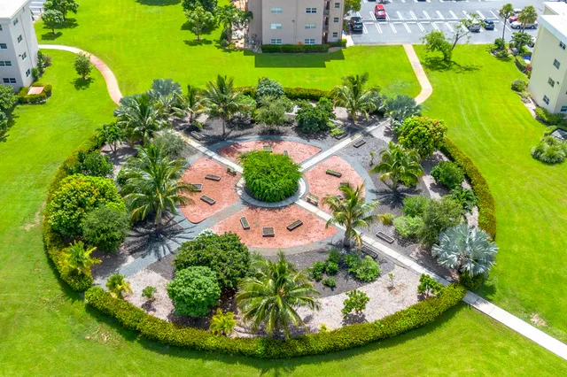 an aerial view of a house with a yard and trees